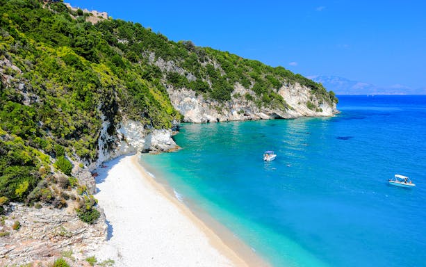 Xigia beach on Zakynthos Island with turquoise waters and boats near the shore.