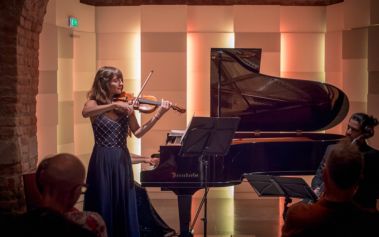 Violinist performing with piano accompaniment at Mozarthaus Vienna concert.