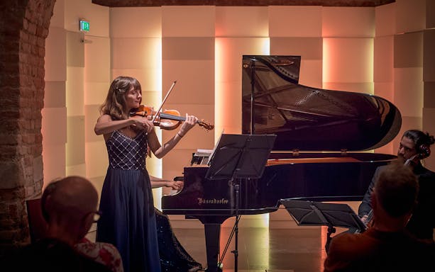 Violinist performing with piano accompaniment at Mozarthaus Vienna concert.