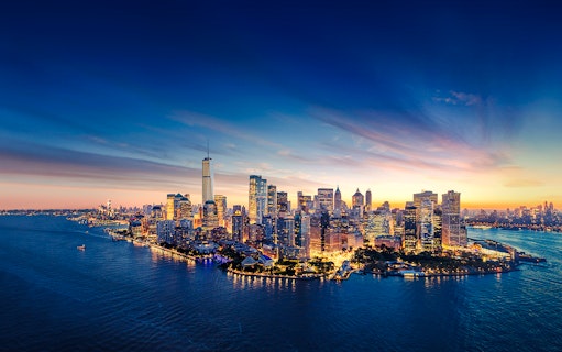 Aerial view of Manhattan skyline at sunset with One World Observatory in New York City.