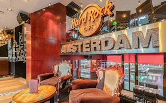 Hard Rock Cafe Amsterdam interior with seating and canal view.