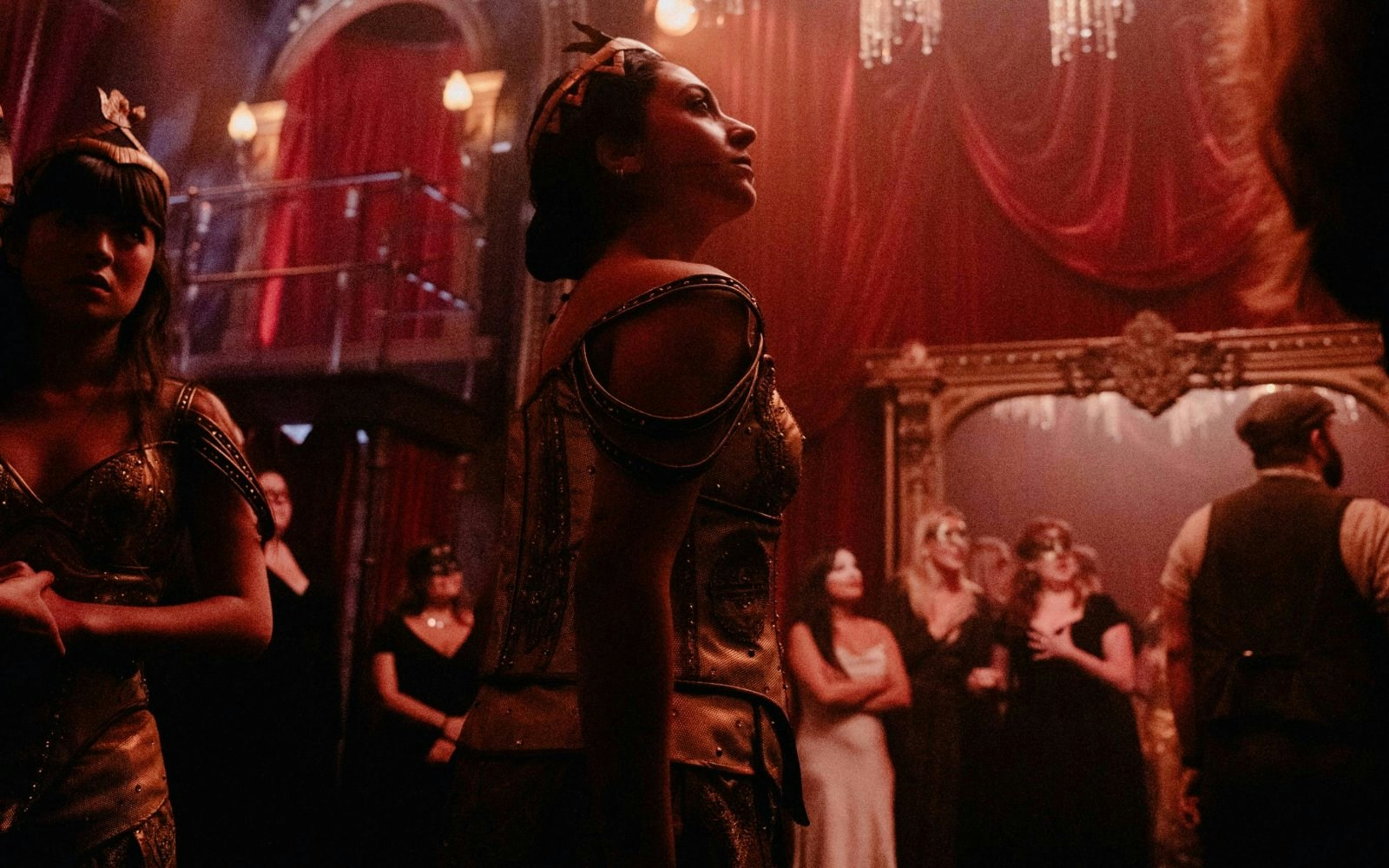 Masquerade Broadway stage performance with actors in ornate costumes and masks.