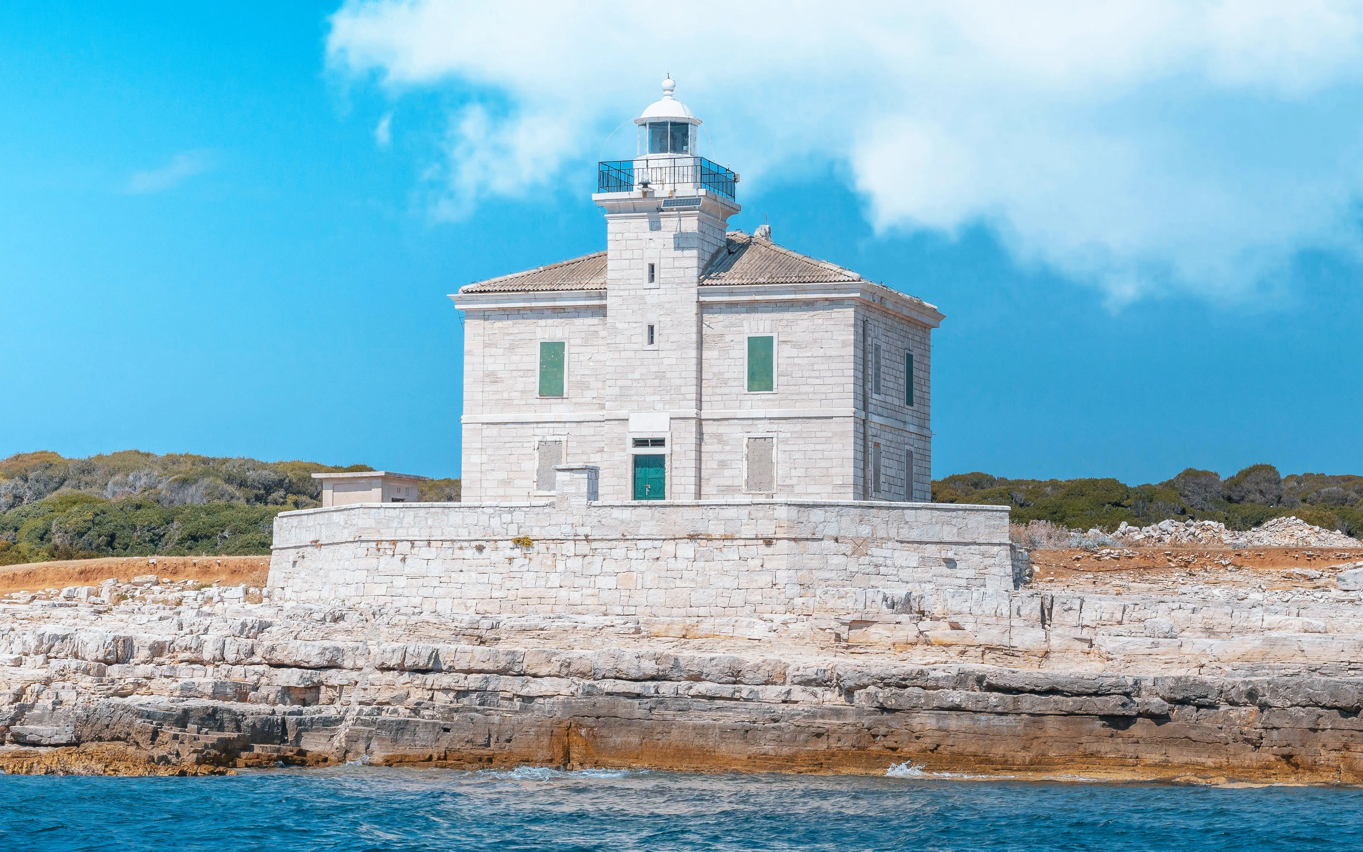 Lighthouse on rocky shore in Brijuni National Park near Pula, Croatia.