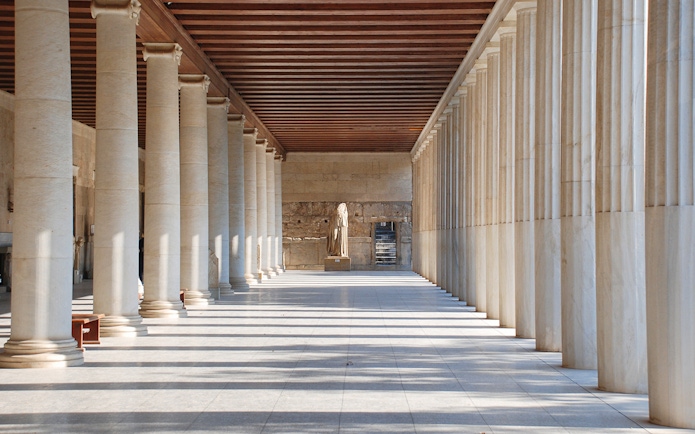 Stoa of Attalos interior with columns and statue, Athens, Greece.