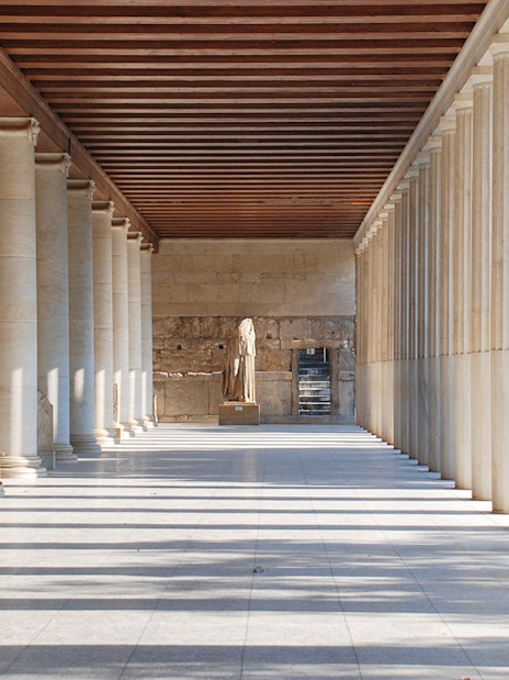 Stoa of Attalos interior with columns and statue, Athens, Greece.