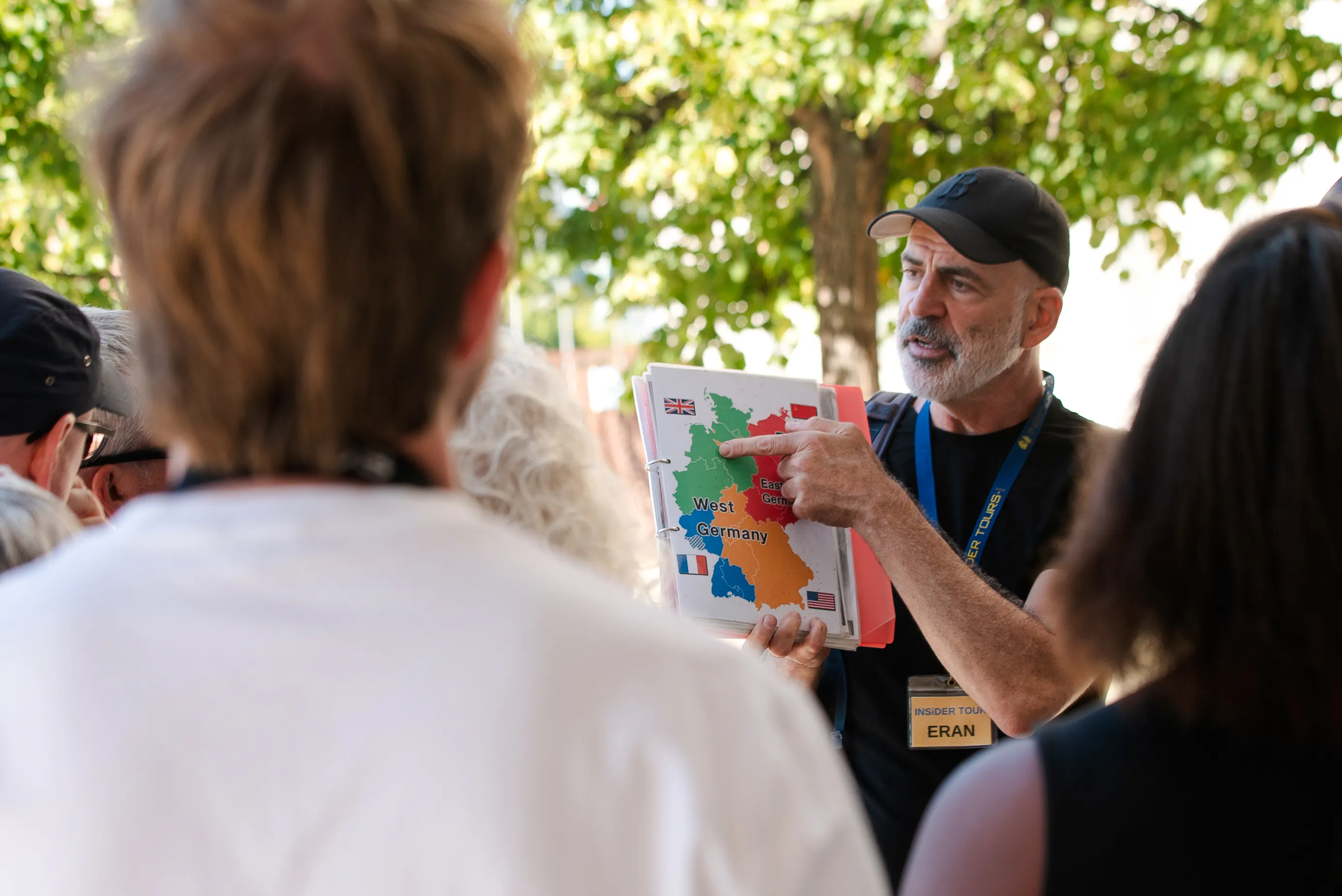 Tour guide explaining Cold War map during Berlin walking tour.