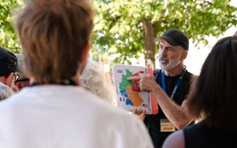 Tour guide explaining Cold War map during Berlin walking tour.