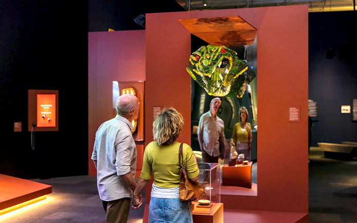 Visitors observing a crocodile sculpture at the Croc! Lost Giants to Living Legends exhibit.