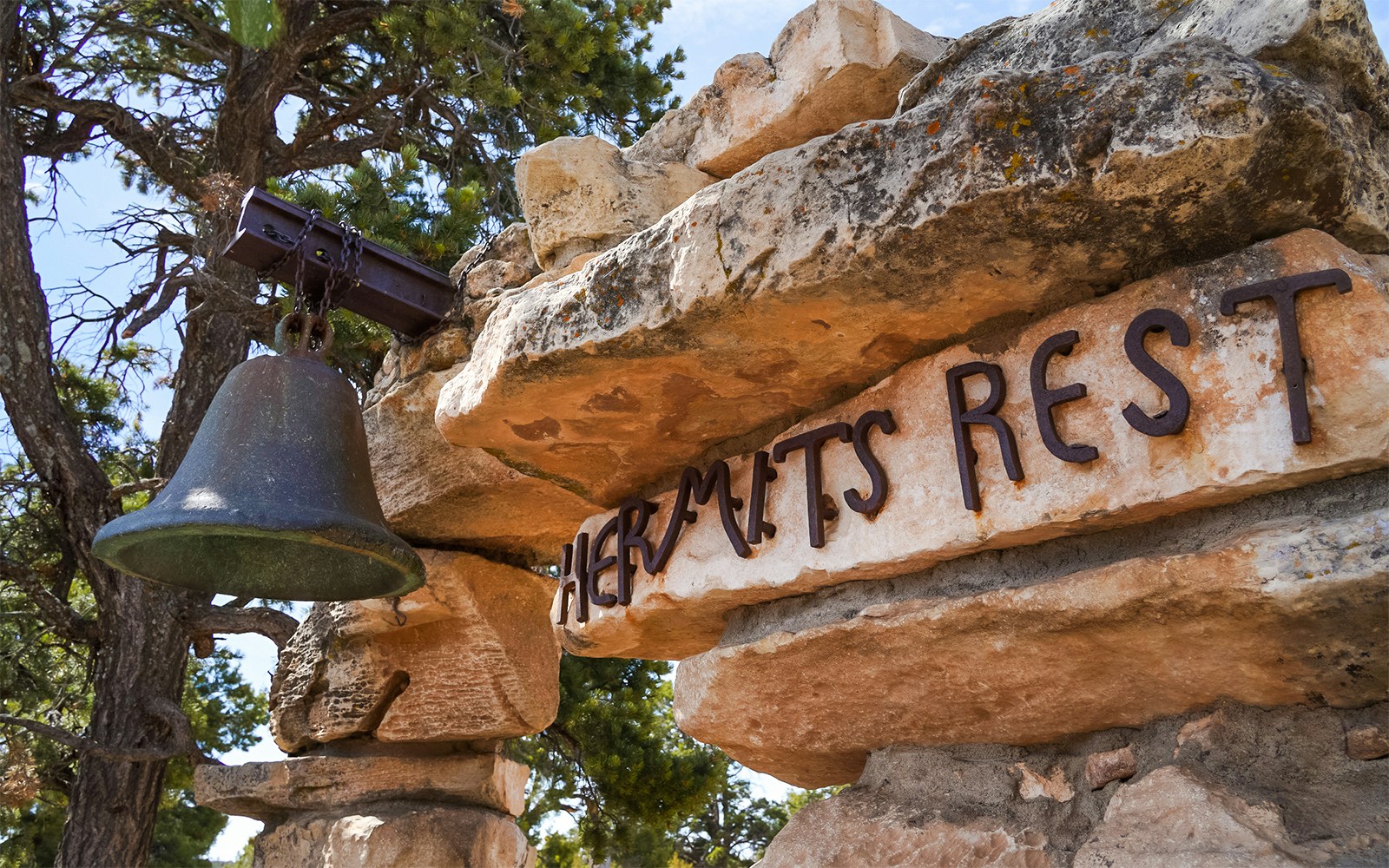 Hermits Rest entrance sign with bell at Grand Canyon.