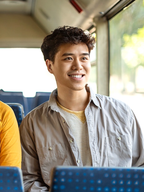 Guests smiling during a bus transfer experience.