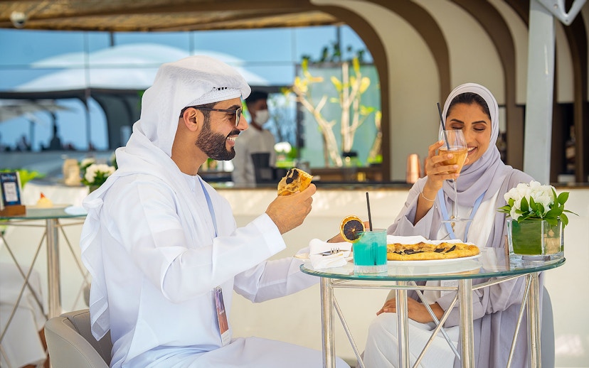 Guests enjoying beverages and snacks during a guided tour inside Burj Al Arab, Dubai.