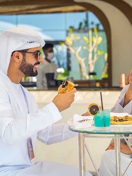 Guests enjoying beverages and snacks during a guided tour inside Burj Al Arab, Dubai.