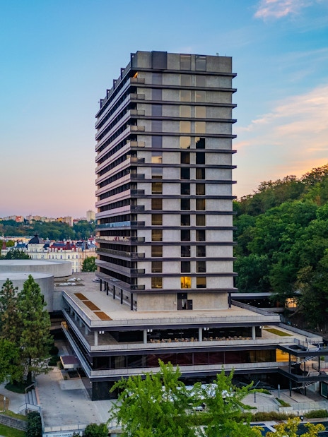 Hotel Thermal building in Karlovy Vary with surrounding greenery and cityscape.