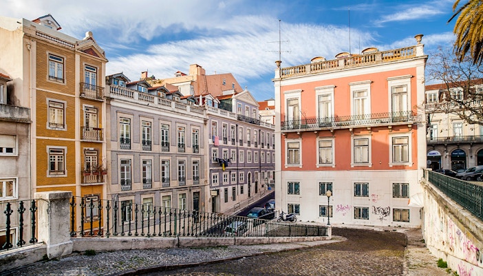 Riders on electric bikes exploring Lisbon hills with cityscape in the background.
