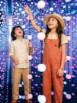 Children enjoying interactive light display at Dopamine Land, Dubai.