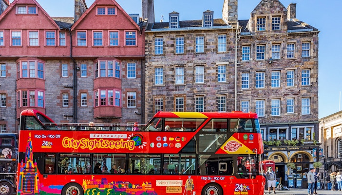 Edinburgh Hop-On Hop-Off bus near historic Royal Mile and Edinburgh Castle.