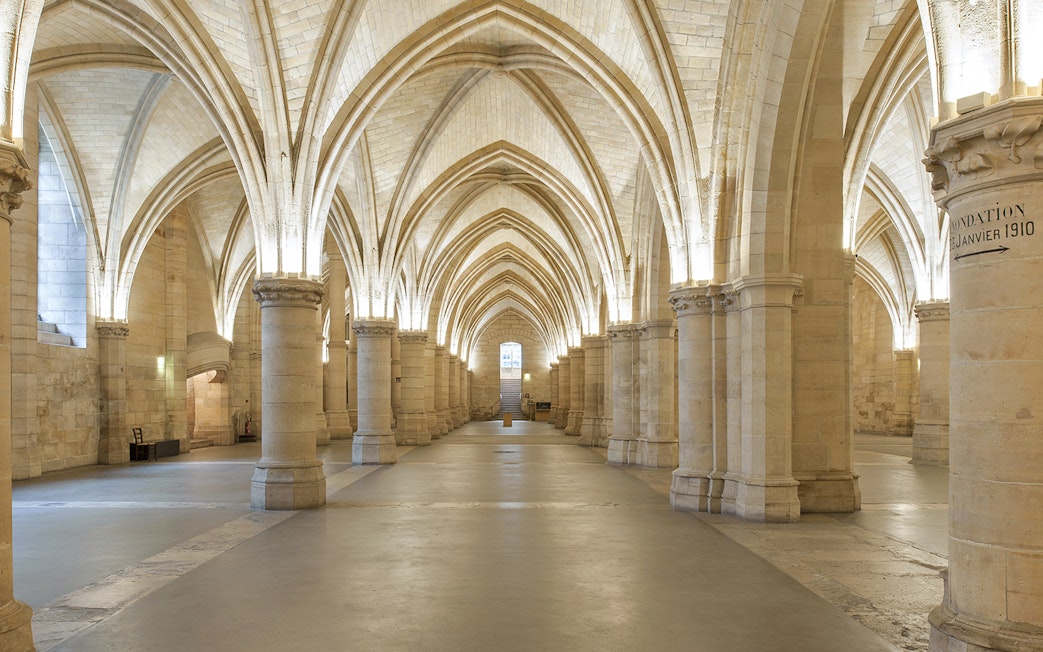 Gothic arches inside the Conciergerie, Paris, with priority access tickets available.
