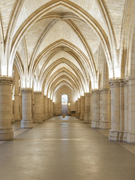 Gothic arches inside the Conciergerie, Paris, with priority access tickets available.