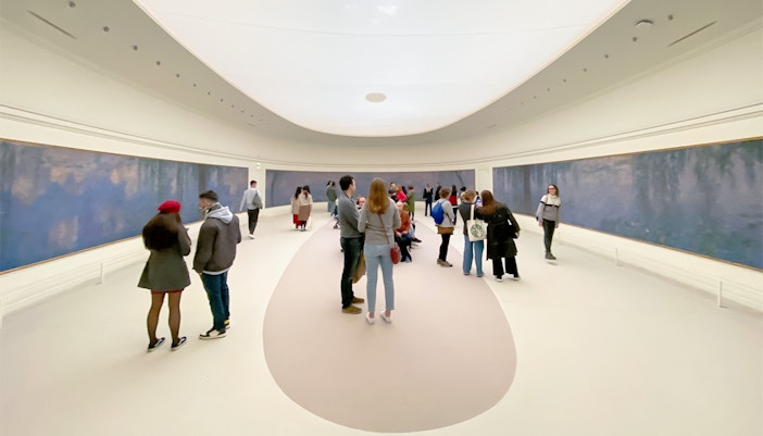 Orangerie Museum exterior in Paris with visitors walking by.