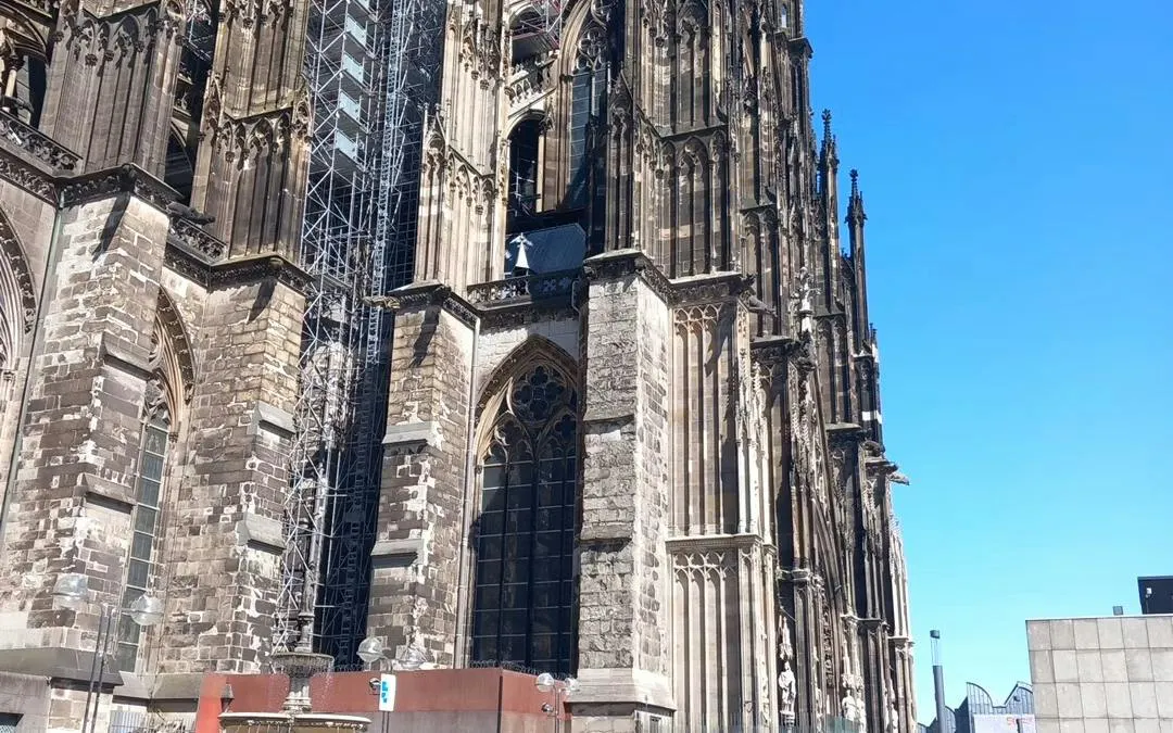 Cologne Cathedral exterior with scaffolding, part of the Cologne Murder Mystery city exploration game.