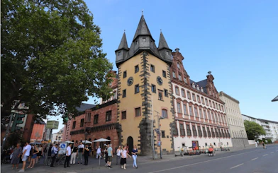 Old Town Frankfurt tower with people exploring the street.