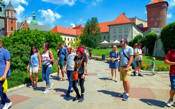 Visitors exploring Wawel Castle grounds on a guided tour in Krakow, Poland.