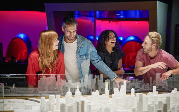Visitors enjoying a model city exhibit at Melbourne Skydeck's Voyager Theatre.