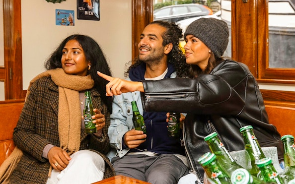Guests enjoying Heineken on a canal cruise in Amsterdam.