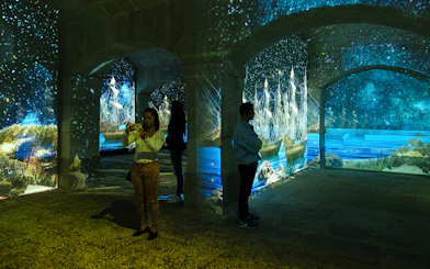 Porto Legends immersive experience with projected ships and stars.