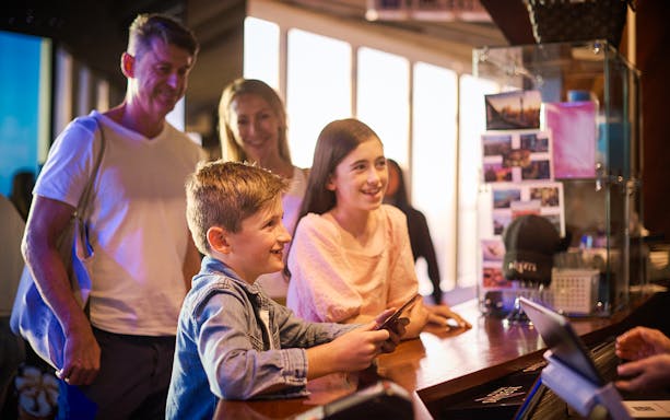 Visitors purchasing tickets at Melbourne Skydeck reception.