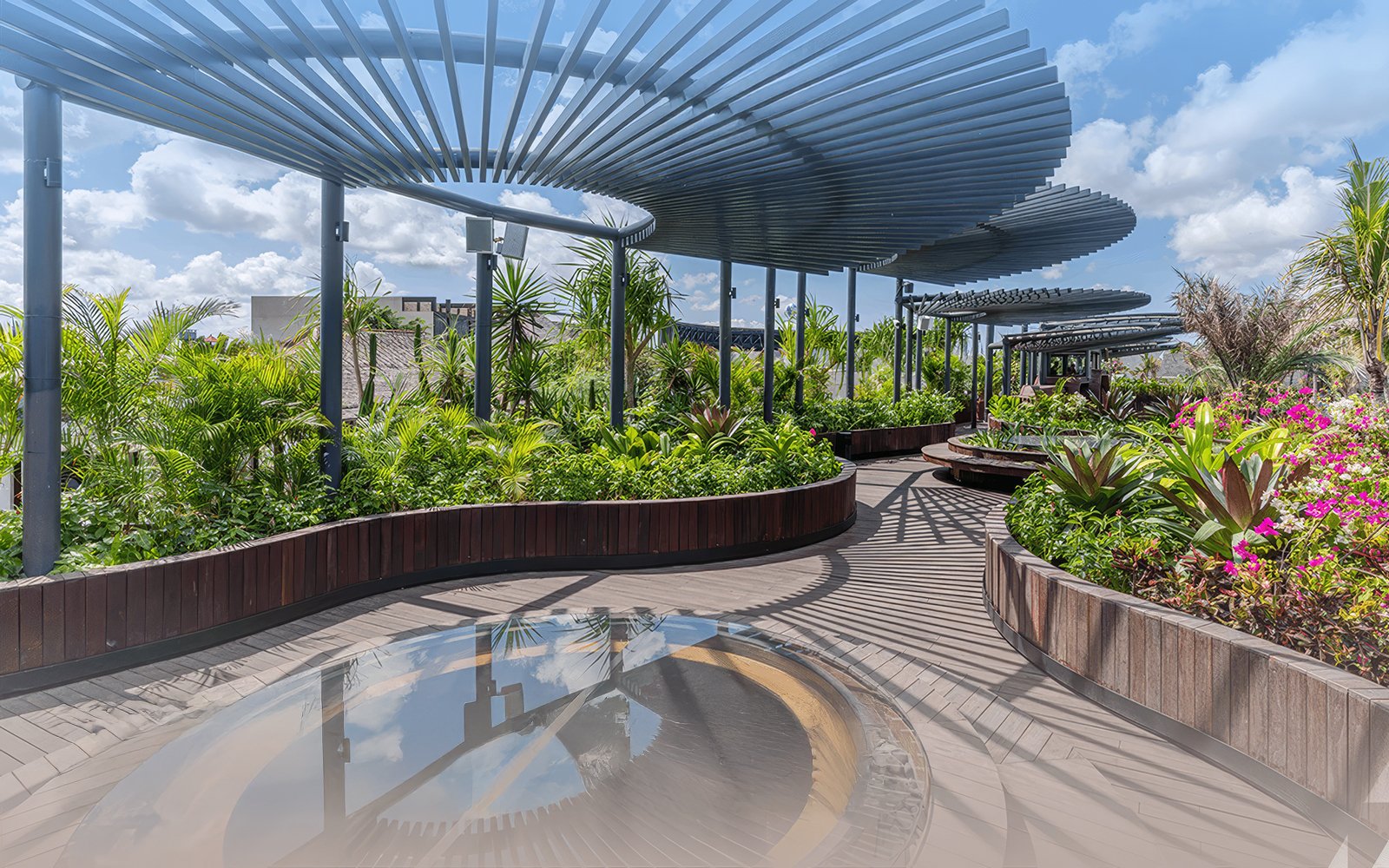 Pathway with greenery and modern pergola at Atlas Beach Club.