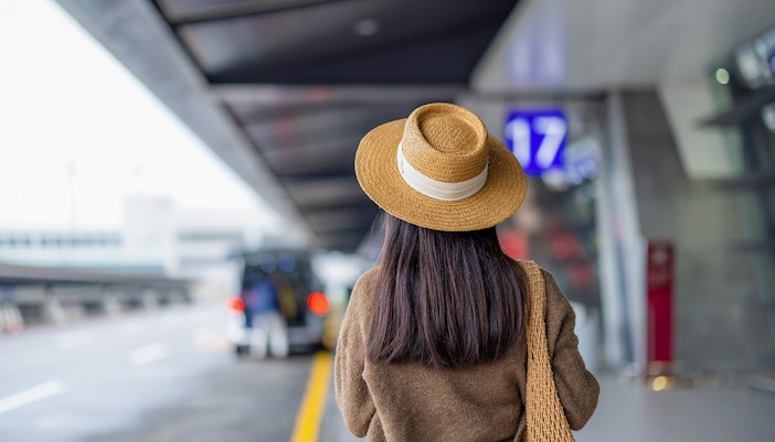 Travel woman wait for the taxi outside airport