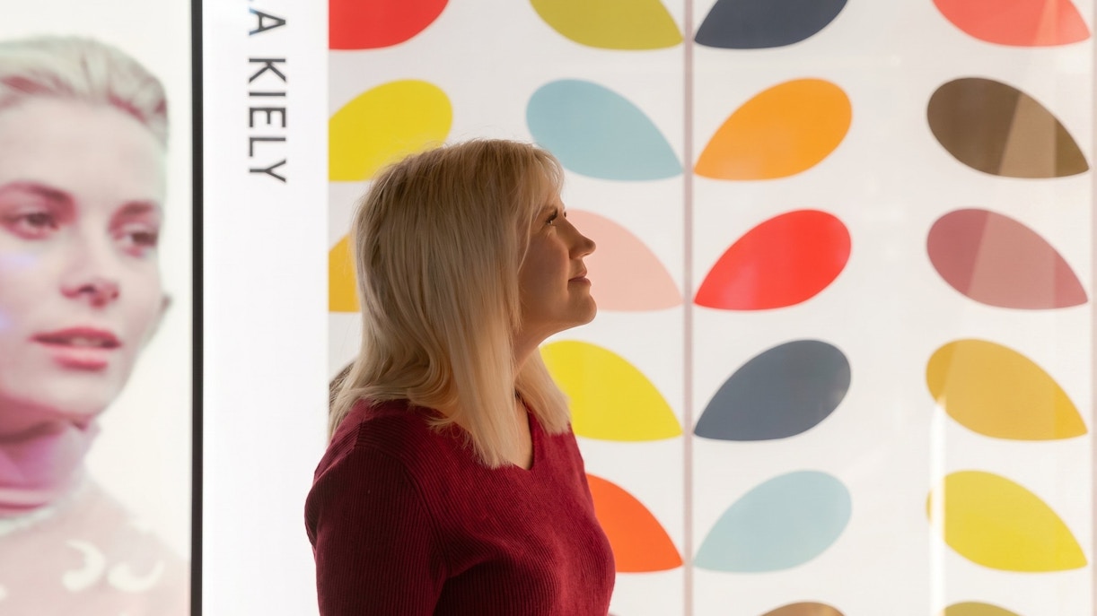Visitor admiring colorful art installation at an epic museum exhibit.