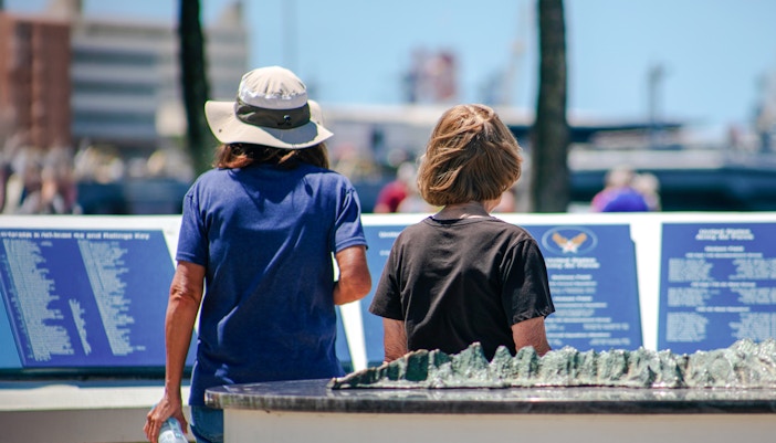 Mother and daughter reading plaques at Pearl Harbor Memorial Center.