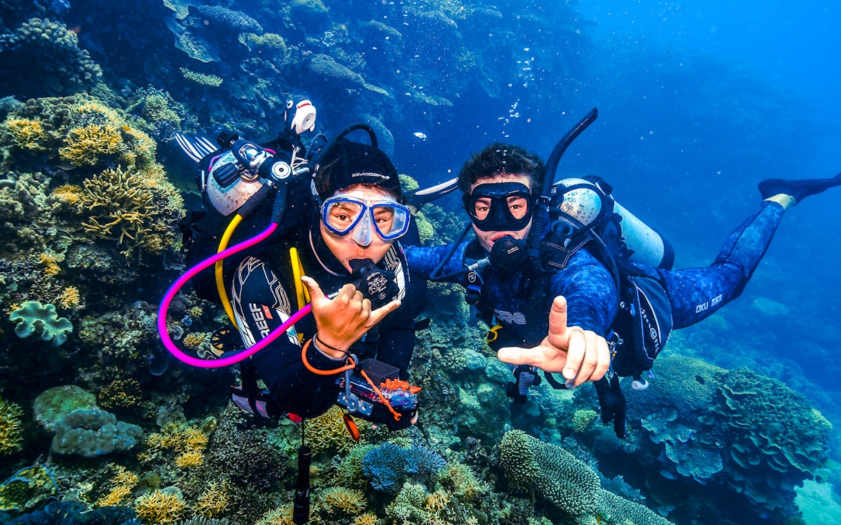 Divers exploring coral formations in the Great Barrier Reef, Australia.