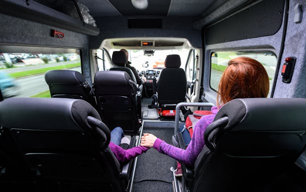 Passengers seated in a van during a shared transfer from Naples Airport to Sorrento.