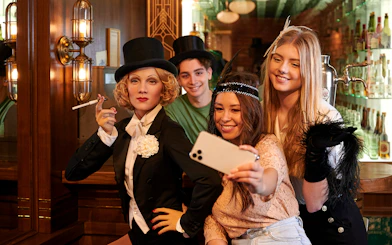Visitors taking a selfie with Marlene Dietrich wax figure at Madame Tussauds Berlin.
