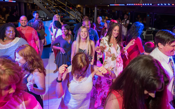Guests enjoying a dance party onboard a cruise ship.