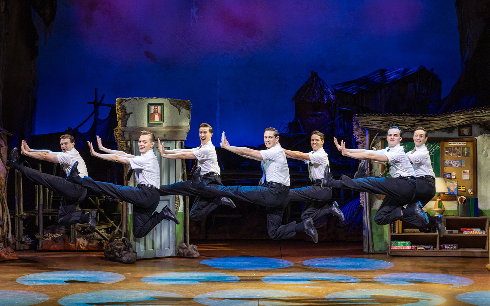 Performers leaping on stage during The Book of Mormon in Sydney.