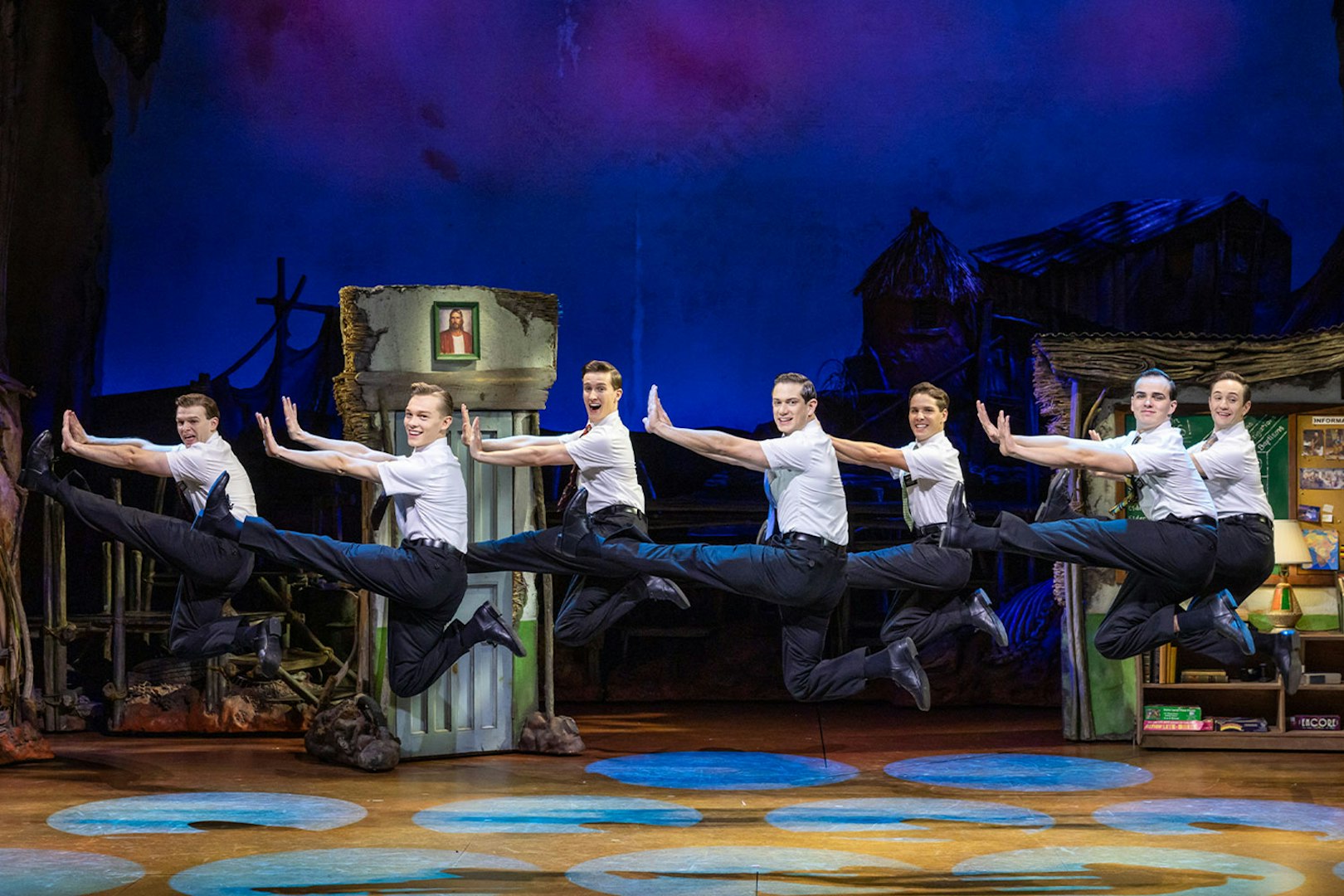 Performers leaping on stage during The Book of Mormon in Sydney.