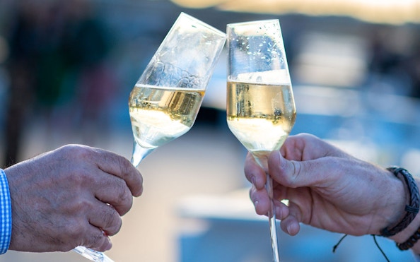Toasting champagne glasses on Le Diamant Bleu Seine River dinner cruise.