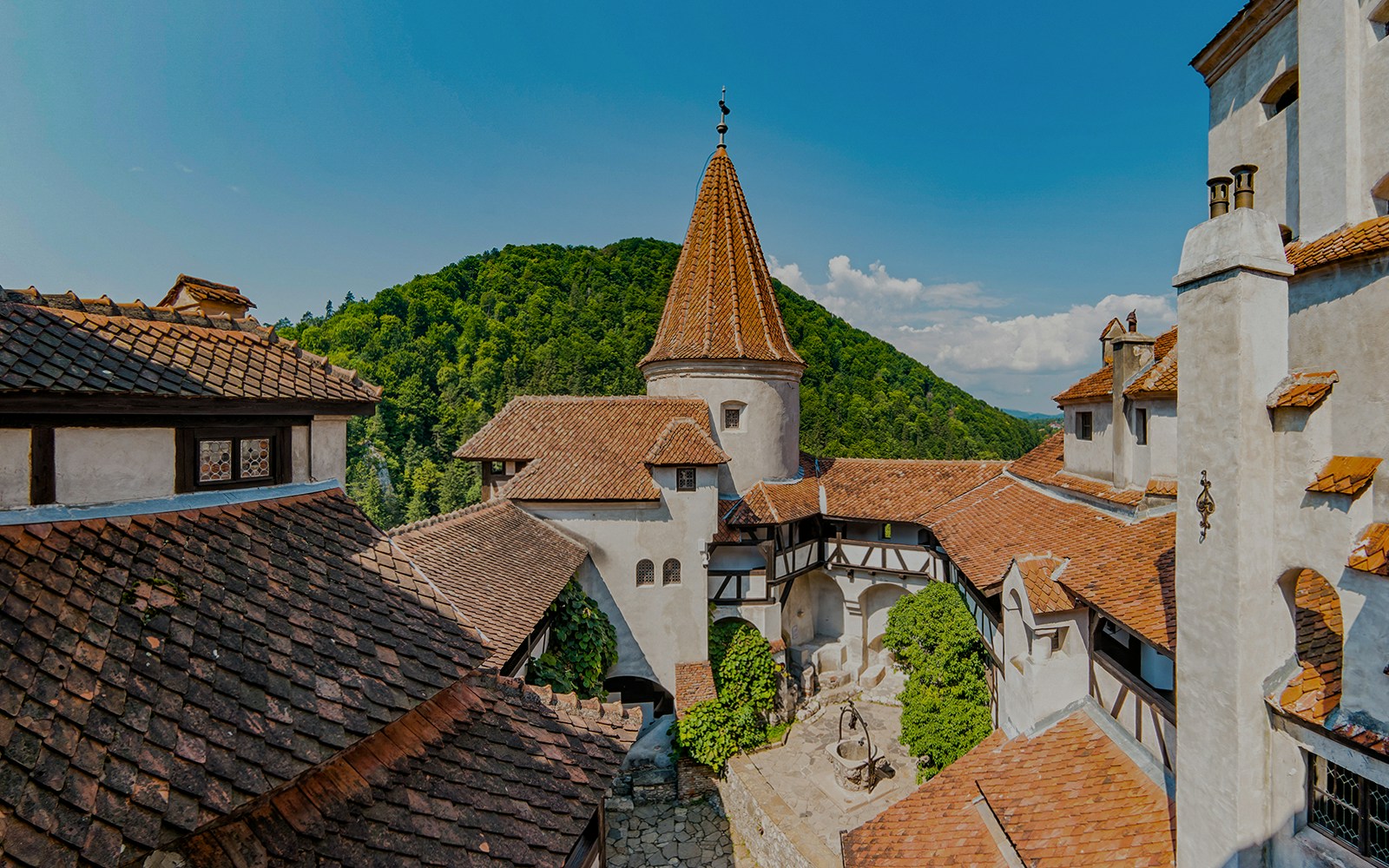 Bran Castle courtyard with view of Donjon tower and surrounding hills.