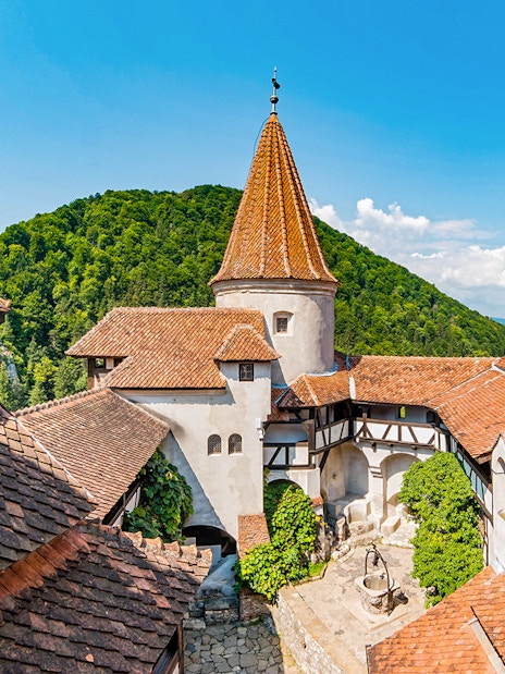 Bran Castle courtyard with view of Donjon tower and surrounding hills.