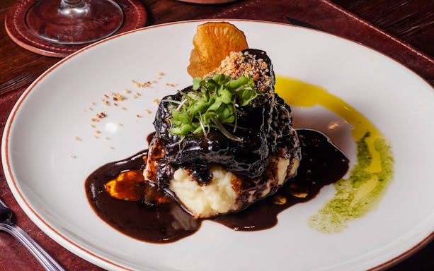 Balsamic-braised pork spare ribs with garnish at Michelangelo Tango Show.