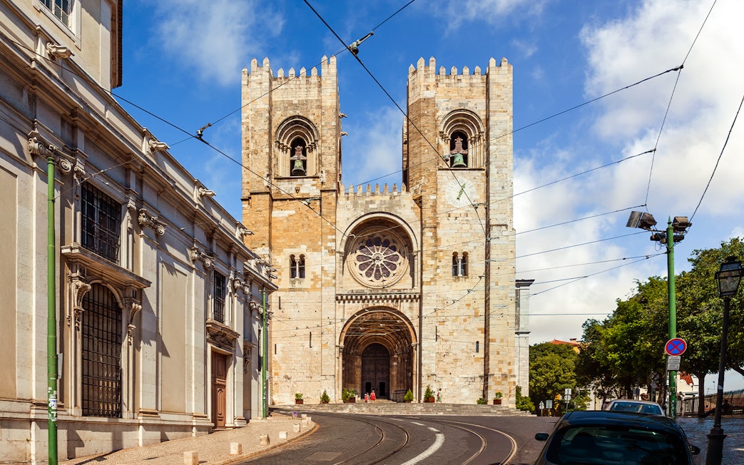 Se de Lisboa cathedral exterior with twin towers and tram tracks, Lisbon, Portugal.