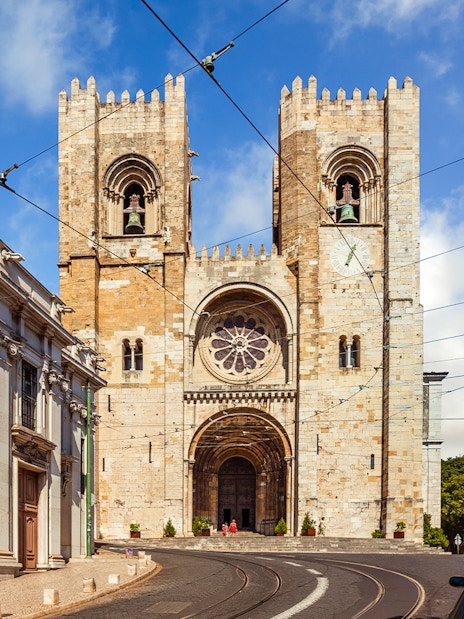 Se de Lisboa cathedral exterior with twin towers and tram tracks, Lisbon, Portugal.