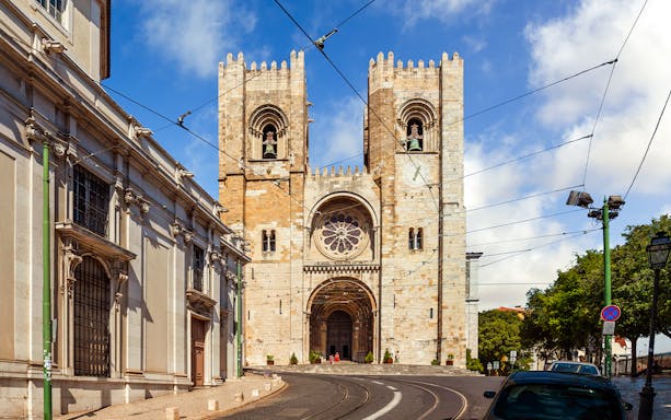 Se de Lisboa cathedral exterior with twin towers and tram tracks, Lisbon, Portugal.