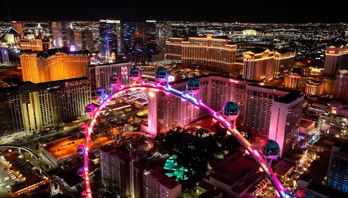 High Roller Ferris wheel illuminated at night in Las Vegas, Nevada with city skyline.