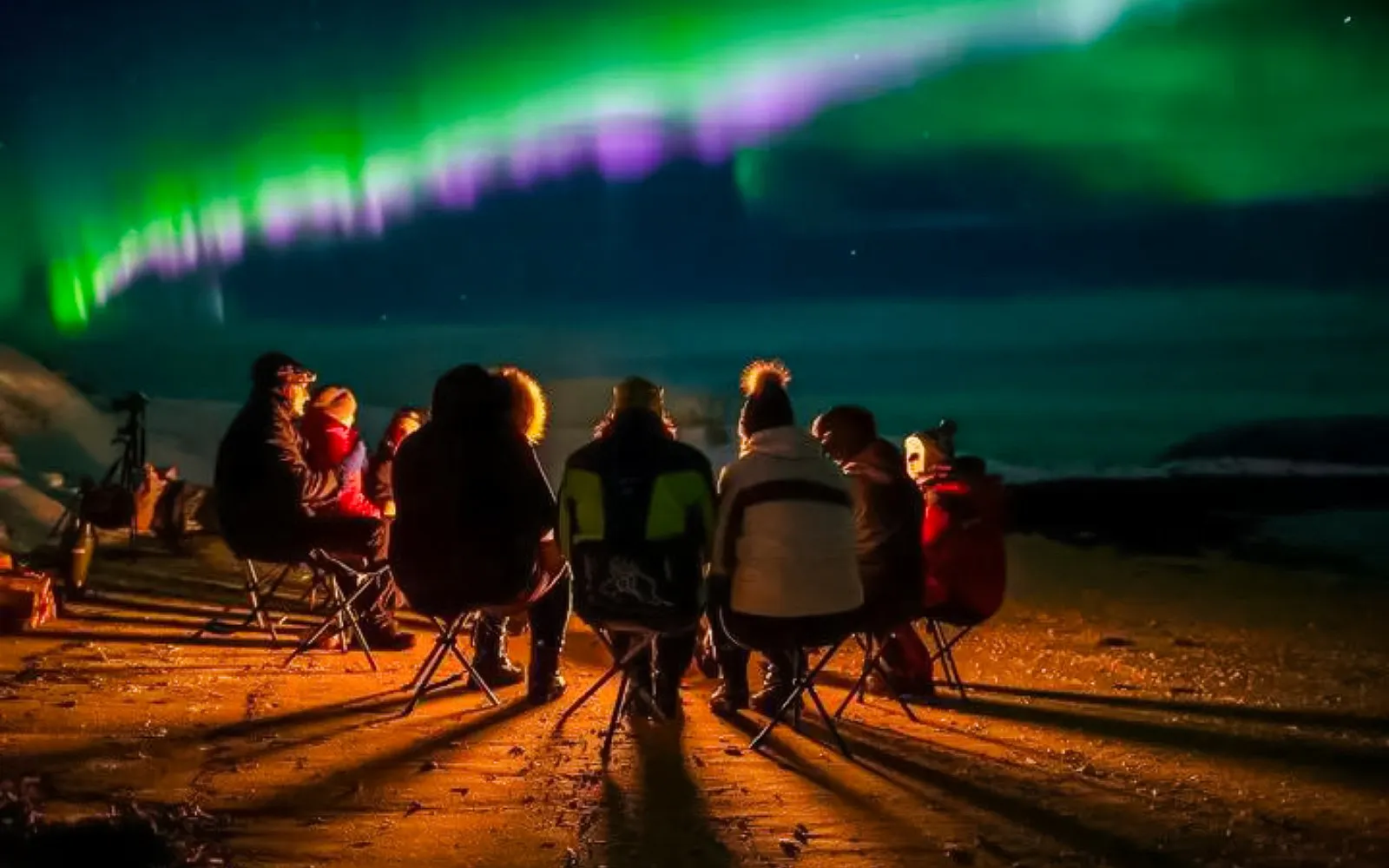 Guests watching northern lights on Northern Lights Chase tour from Tromso.