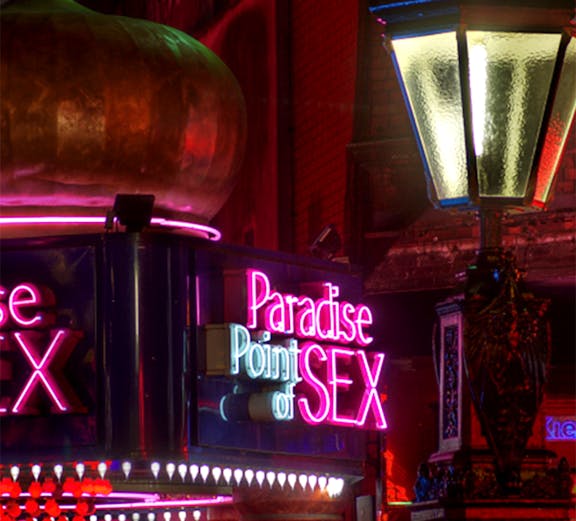 Neon signs and street lamp on Reeperbahn, St. Pauli, Hamburg.